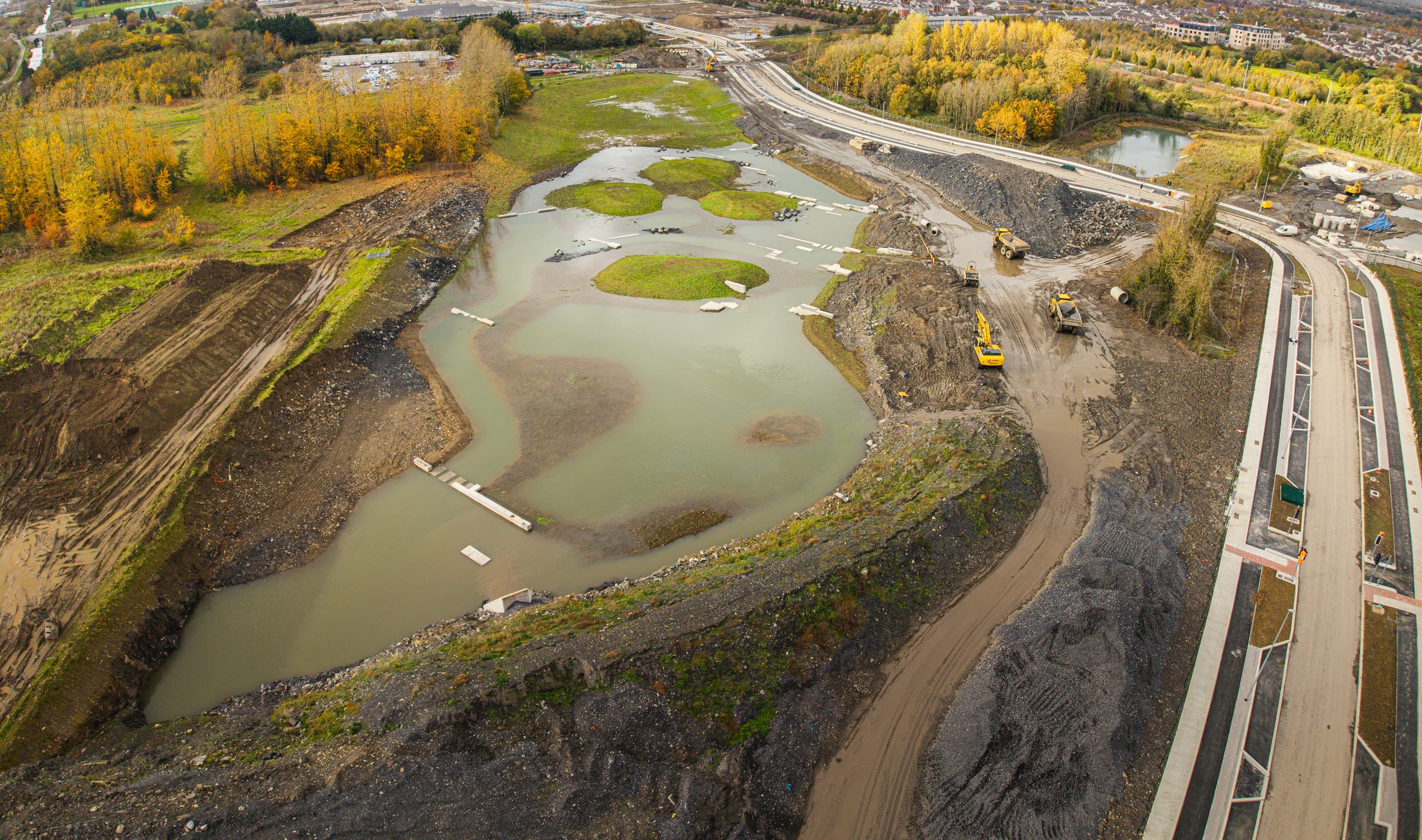Aerial view of the development site in May 2025 with landscaping and water features taking shape