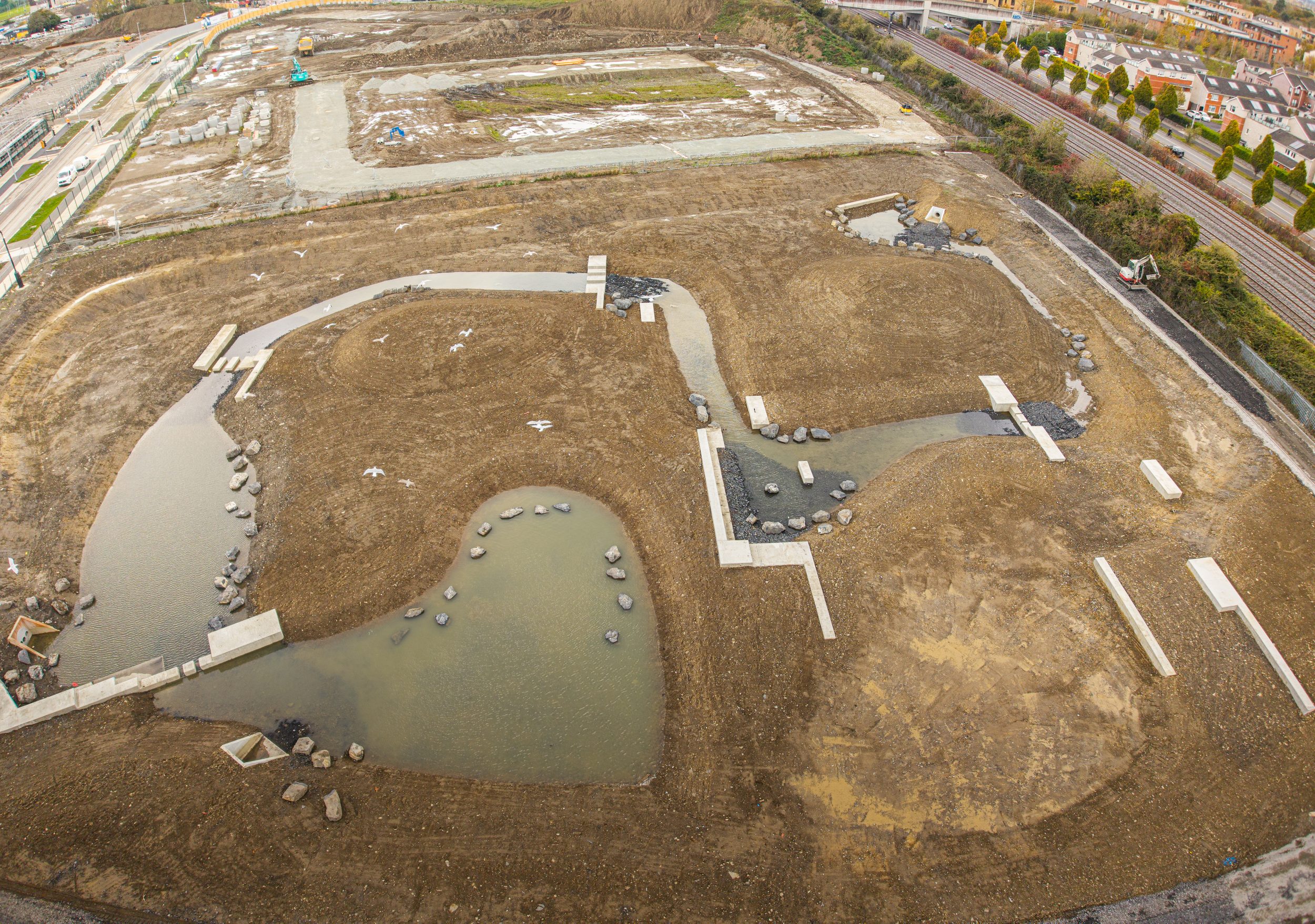 Aerial view of newly formed ponds and pathways at the development site in May 2025